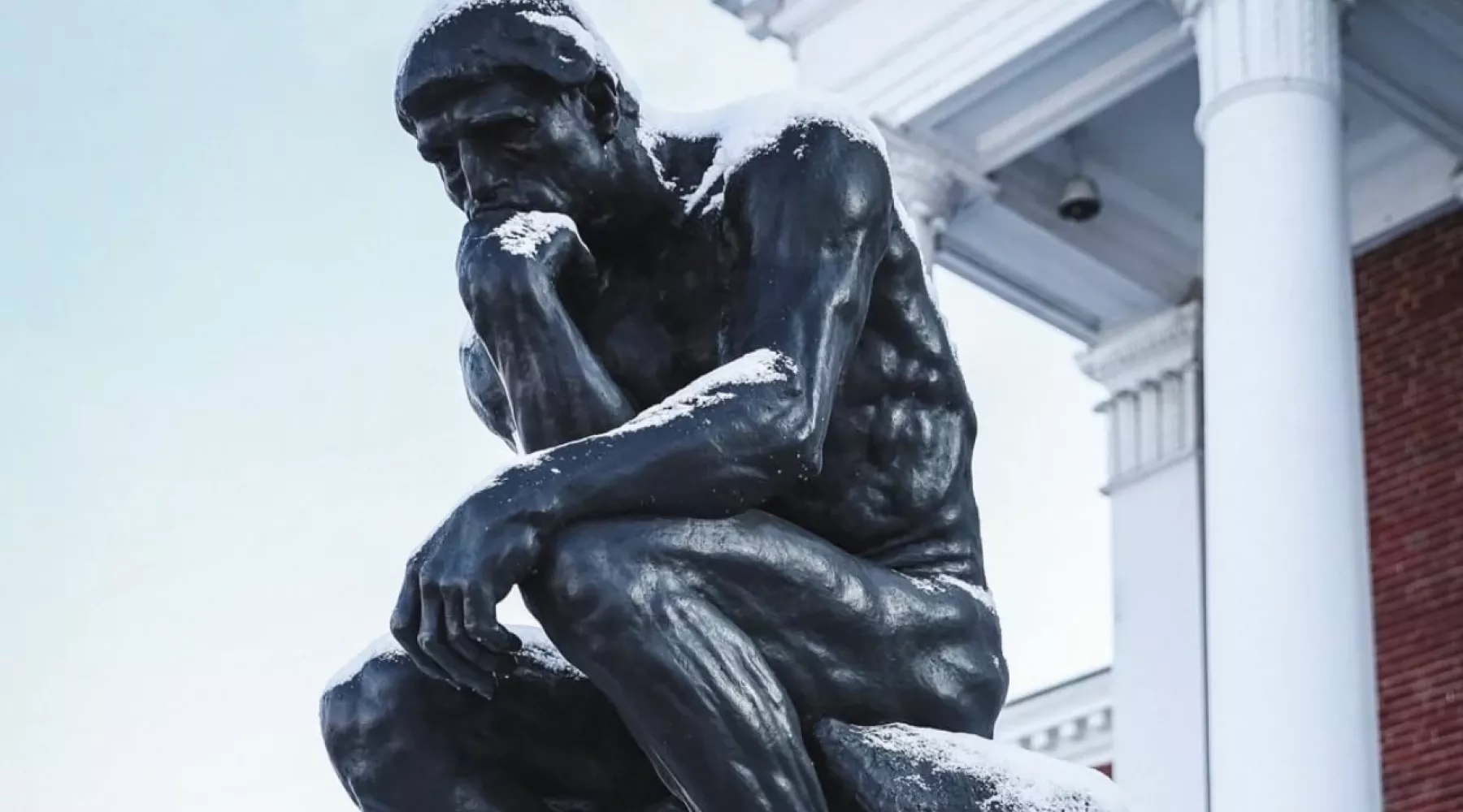 The thinker dusted in snow