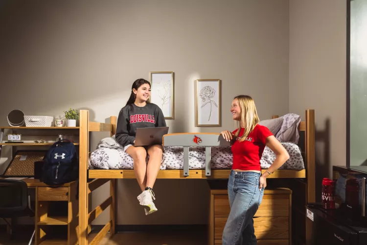 Two UofL students talking in a dorm room on campus