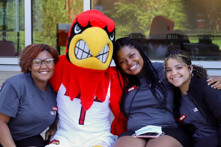 Staff sitting with Cardinal