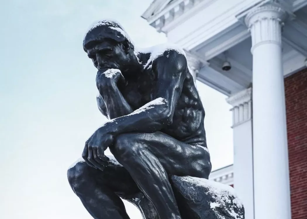 The thinker dusted in snow