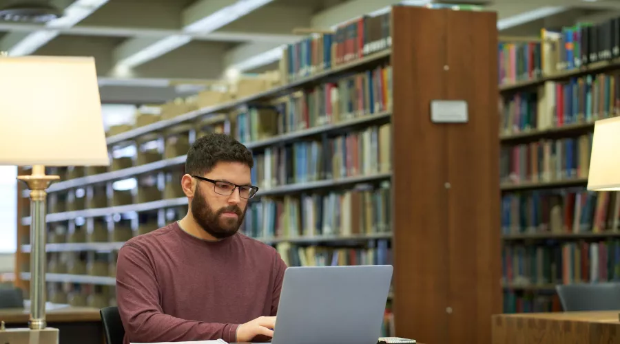 Student studies in the library.