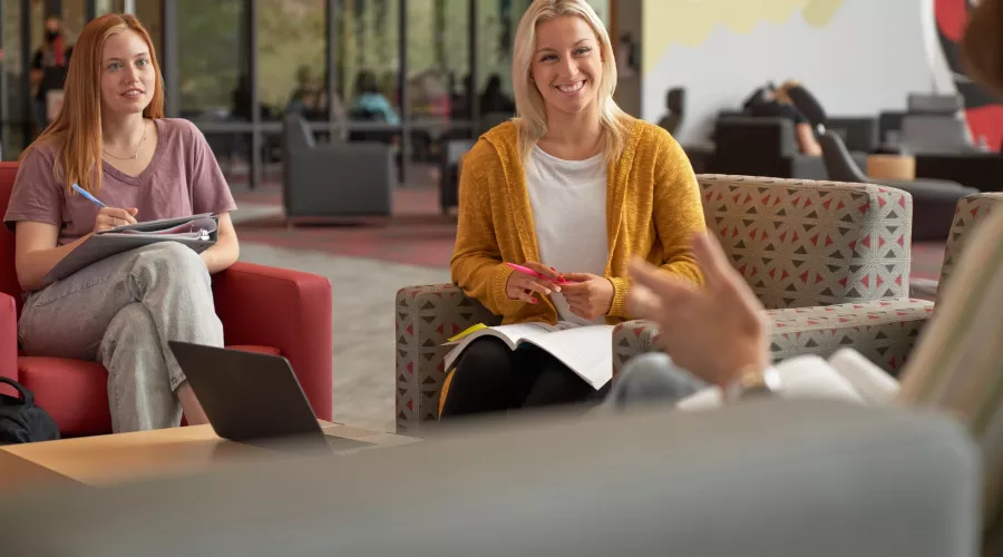 Students sitting around and talking in the SAC.