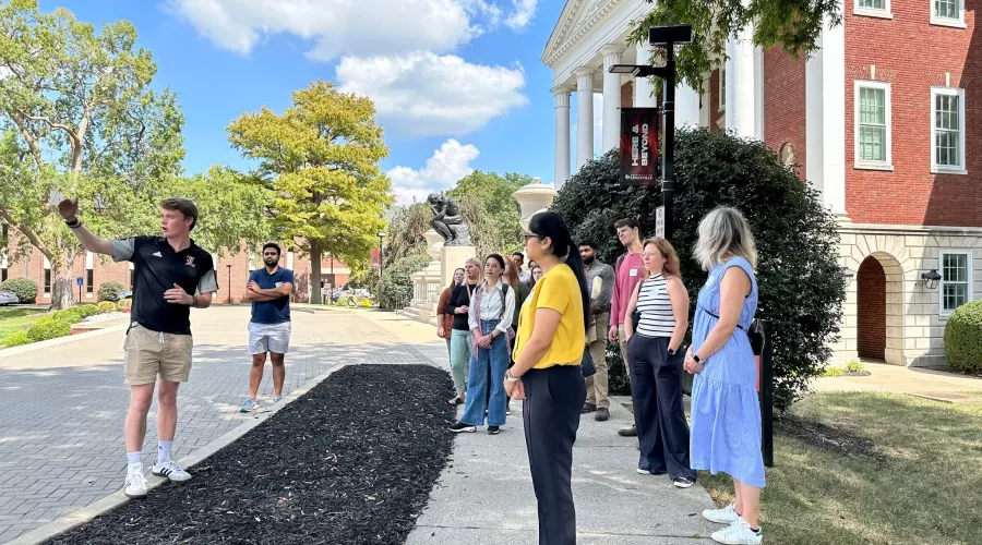 New Employee Orientation group touring Belknap Campus out front of Grawemeyer Hall