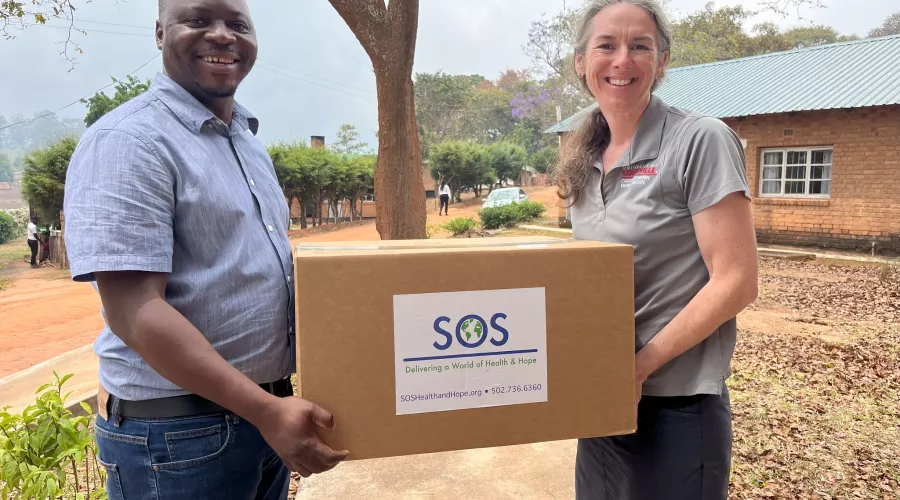 Man and woman holding a box of medical and research supplies in Malawi